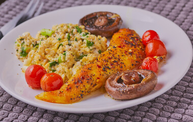 Fish with scrambled eggs and vegetables.