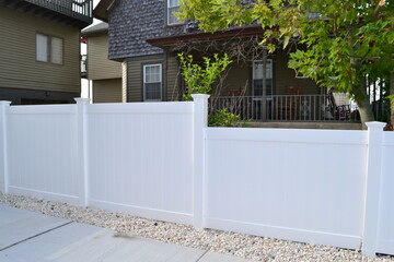 White vinyl fence with step down fence