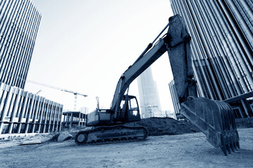 Excavator on construction site office building