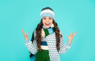 express positive emotion. winter fashion. amazed emotional kid with curly hair in hat and scarf