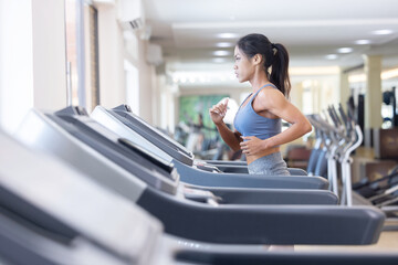 Woman Running on Treadmill in a Fitness
