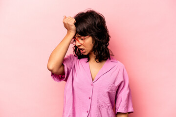 Young hispanic woman isolated on pink background forgetting something, slapping forehead with palm and closing eyes.