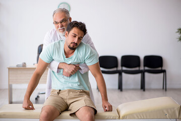 Young male patient visiting old male doctor