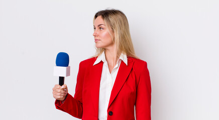 blonde pretty woman on profile view thinking, imagining or daydreaming. preporter and microphone...