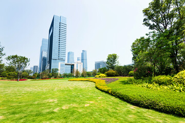 Green park next to business center buildings