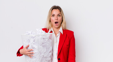 blonde pretty woman looking very shocked or surprised. paper balls mistakes concept