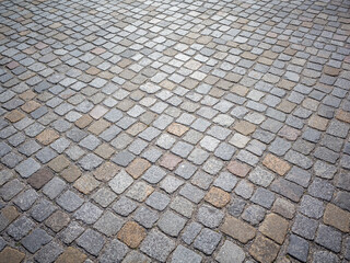cobblestone surface of a city square. 
gray paved road or driveway.