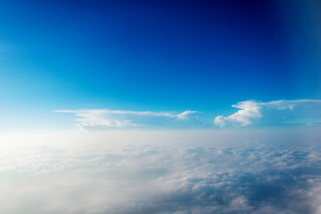 Blue sky and white cloud from airplane window