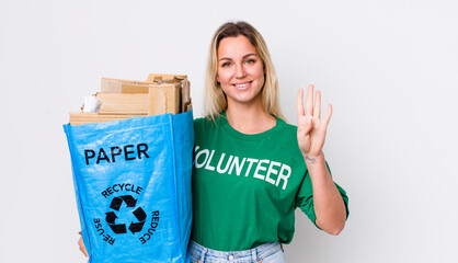 blonde pretty woman smiling and looking friendly, showing number four. recycle concept