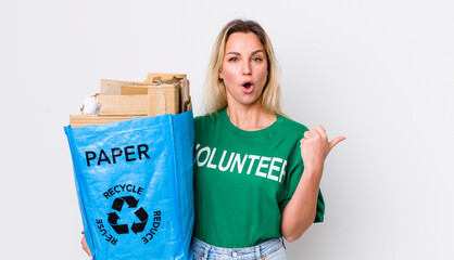 blonde pretty woman looking astonished in disbelief. recycle concept