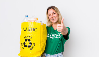 blonde pretty woman feeling proud,smiling positively with thumbs up. recycle concept