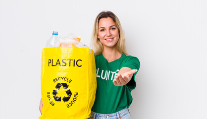 blonde pretty woman smiling happily with friendly and  offering and showing a concept. recycle...