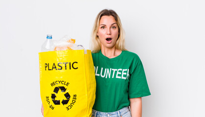 blonde pretty woman looking very shocked or surprised. recycle concept