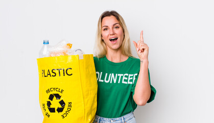 blonde pretty woman feeling like a happy and excited genius after realizing an idea. recycle concept