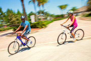 Fototapeta premium Afro American couple enjoying outdoor exercise riding bikes