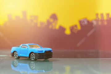 blue muscle car toy selective focus on blur city background