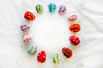 A pattern of crocheted Easter eggs. A flat layer of fancy Easter eggs. Happy Easter card