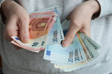  a woman counts banknotes with her hands. European money, euro.