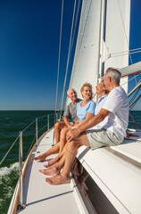Senior American friends relaxing together on luxury yacht