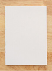 White cover of sketching book on wood for art background.