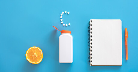 Flat lay, pills on blue background, vitamin c concept.