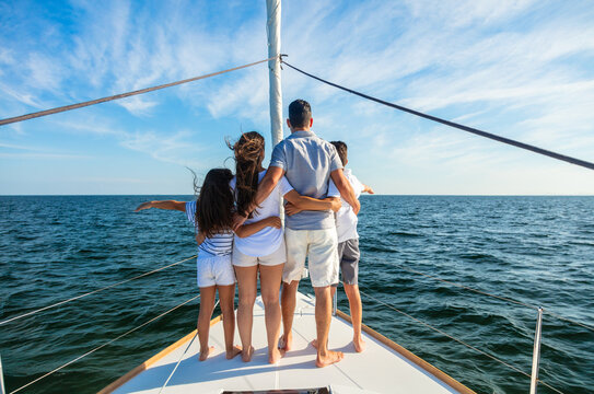 Young Latino Family Standing Together On Private Yacht