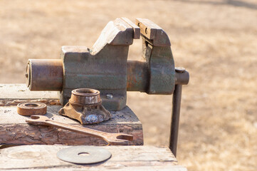 A closeup of the bench vise in the wooden mechanical workshop
