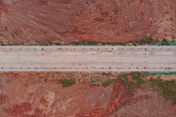 Aerial top view of unfinished city road and land