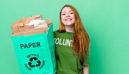 red head pretty woman looking happy and pleasantly surprised. recycling concept