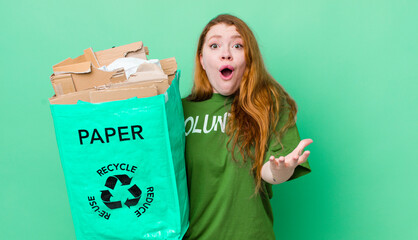 red head pretty woman feeling extremely shocked and surprised. recycling concept