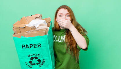 red head pretty woman covering mouth with hands with a shocked. recycling concept