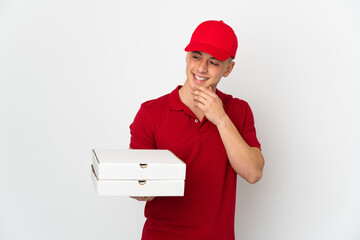 Pizza delivery man with work uniform picking up pizza boxes isolated on white background looking to...
