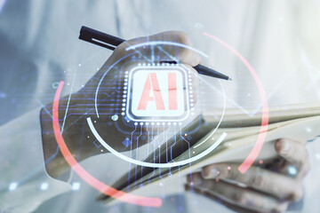 Double exposure of creative artificial Intelligence abbreviation with man hand writing in notepad...