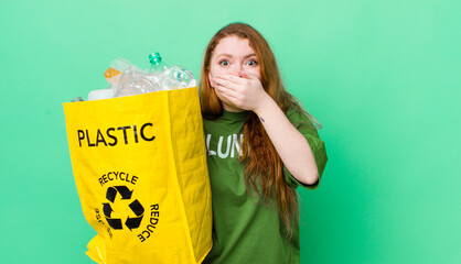 red head pretty woman covering mouth with hands with a shocked. recycling concept