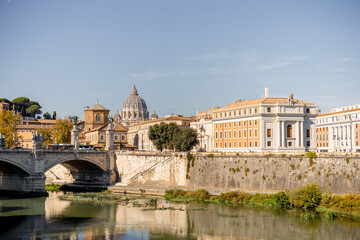 Landscape of Tiber river at sunny morning in Rome. Dome of famous saint Peter basalica on the...