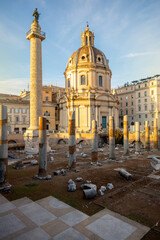Fototapeta na wymiar Ruins of Roman forum with Trajan column and church of the Most Holy Name of Mary. Rome cityscape on sunset. Concept of historical landmarks and travel Italy