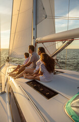 Latin American family relaxing on yacht at sunset