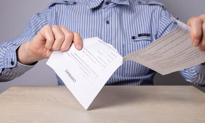 Man hands closeup tearing contract. Cancellation of deal or arrangement. Dismissal concept. Man...
