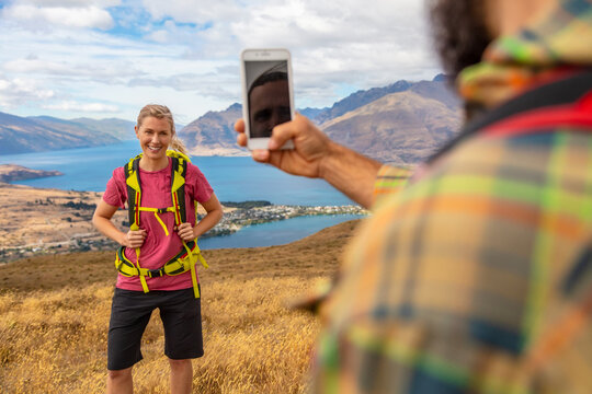Adventure couple taking picture Lake Wakatipu South Island