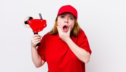 red head pretty woman with mouth and eyes wide open and hand on chin. packer employee concept