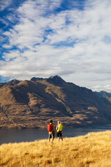 Fototapeta premium Hikers on trekking expedition enjoying view Lake Wakatipu