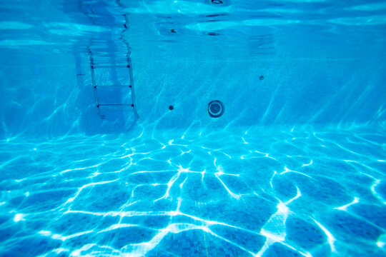 Underwater pool floor photo of rails and ladder stairs