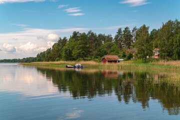 Sweden, Loftahammar, Small house on grassy coast © Image Source RF