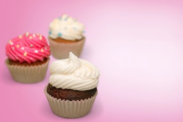 Sweet upcakes with cream cheese decorated with dried cinnamon powder. Homemade pastry