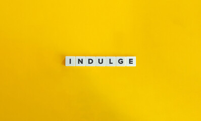 Indulge Word on Letter Tiles on Yellow Background. Minimal Aesthetics.