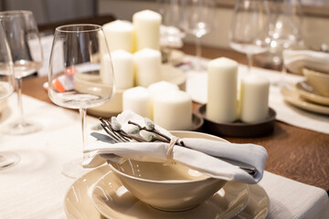 Festive Easter table setting with beige plates and floral decor on Stylish table background.happy Easter holiday table with pussy willow branches
