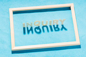 inside a wooden frame on a blue background an inscription from wooden letters - request