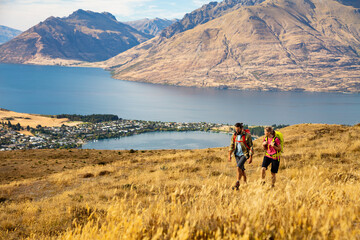 Fototapeta na wymiar The Remarkables young Caucasian couple trekking Lake Wakatipu