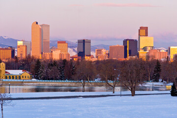 Denver City Park Dawn - Denver downtown skyline as sun turns high rise glass a golden color with a...
