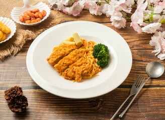 pasta spaghetti with chicken thighs in dish side view on wooden table taiwan style food